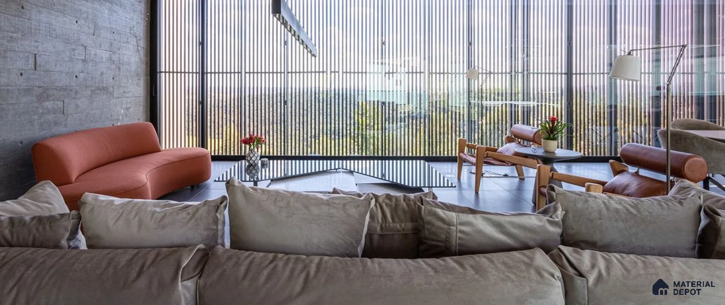 a living room filled with lots of furniture and a large windows in the center of it next to a window covered in front of a window covered in a room filled with lots of plants and bookshelves covered